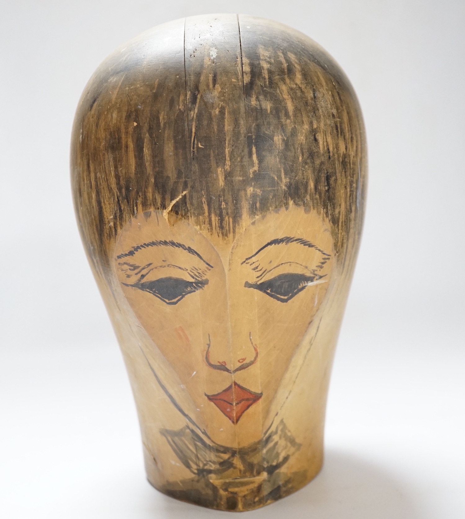 A Hatter's block with hand painted face, stamped Zurich to the base, 25cm high